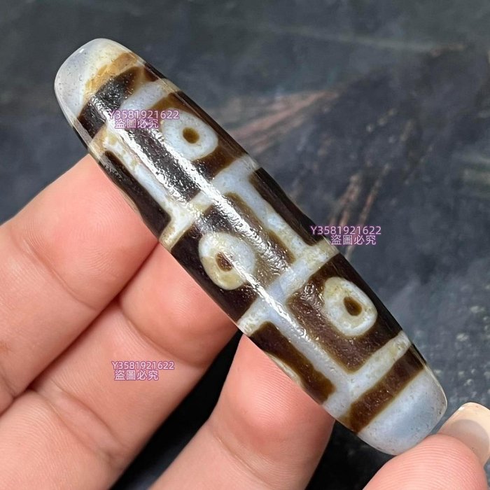 15750藏傳佛教高油包漿佛心九眼天珠尺寸57*14毫米風化清晰明顯，包漿