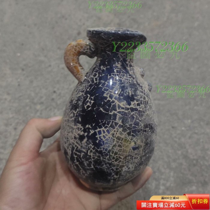 唐三彩紫釉開片紋執壺，胎體厚重，瓶身呈現獨特的開片紋理，釉色