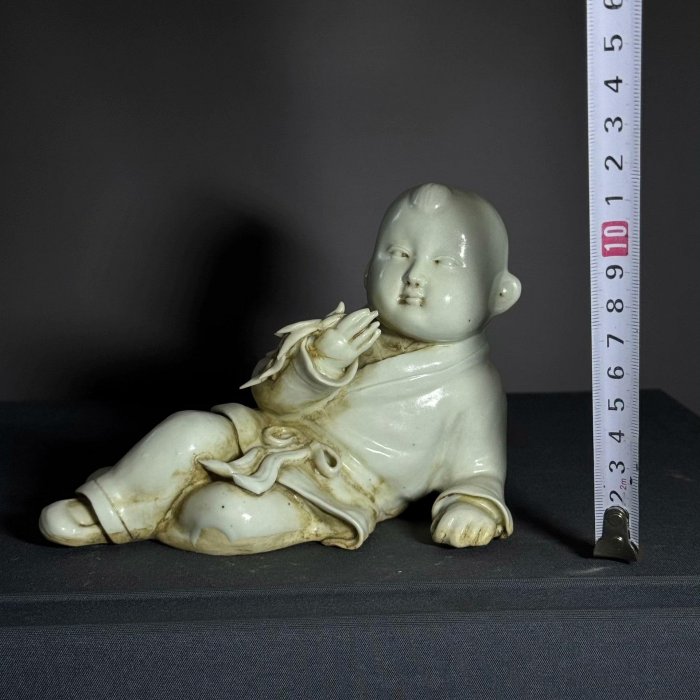 宋代湖田窯影青釉童子瓷塑器型古樸生動童子側臥持物釉色溫潤胎質細膩