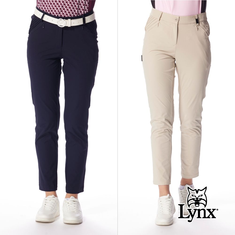 【Lynx Golf】女款修身俐落九分窄筒壓摺設計褲耳飾片時尚設計長褲(二色) (深藍色)