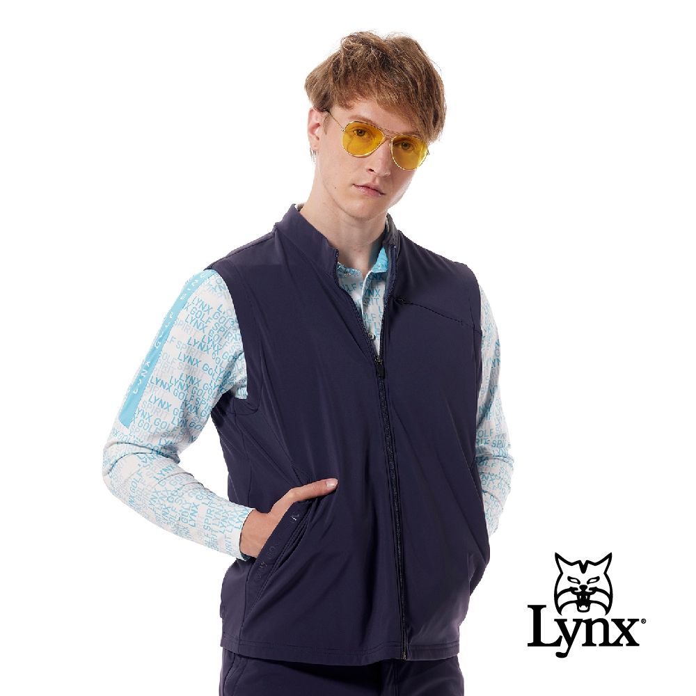 【Lynx Golf】男款保暖防風防潑水四面彈性內刷毛羅紋織帶剪接造型膠印拉鍊口袋無袖背心(二色) (深藍色)
